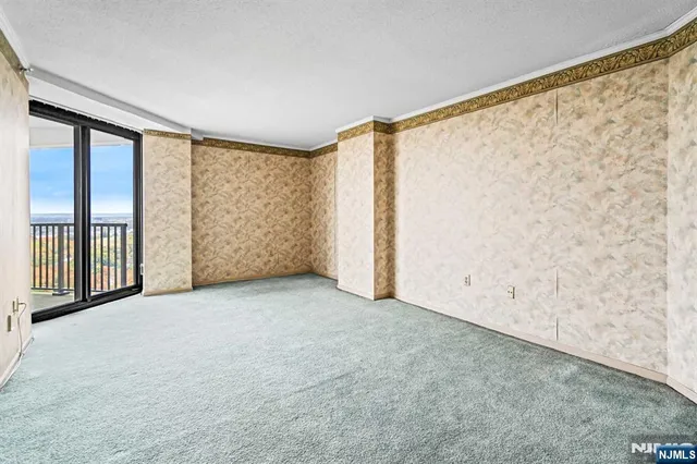 a lobby with furniture and floor to ceiling windows