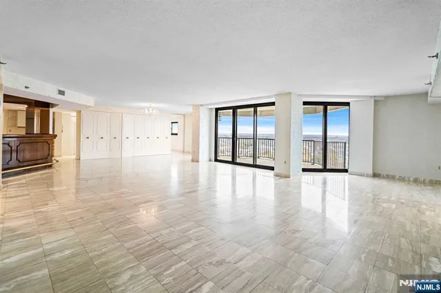 a view of a dining room with furniture large windows and wooden floor