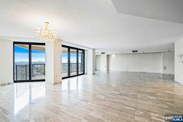 a kitchen with stainless steel appliances granite countertop a sink and a refrigerator