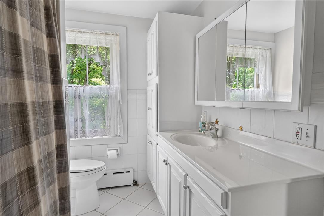 765 East Macada Road Bethlehem, PA 18017 - Photo 35 of 46 A well-lit primary bathroom featuring a classic vanity, ample storage, and a private window view.