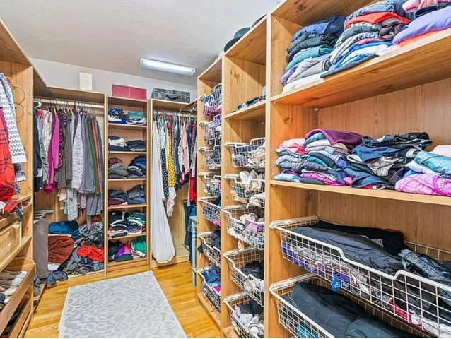 a view of walk in closet with clothes