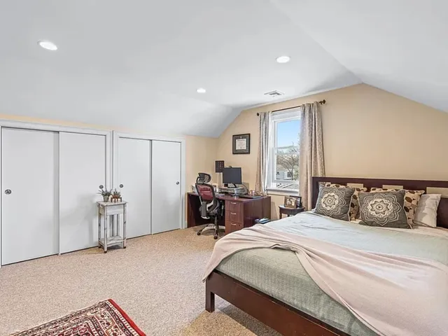 a bedroom with a large bed and a large window