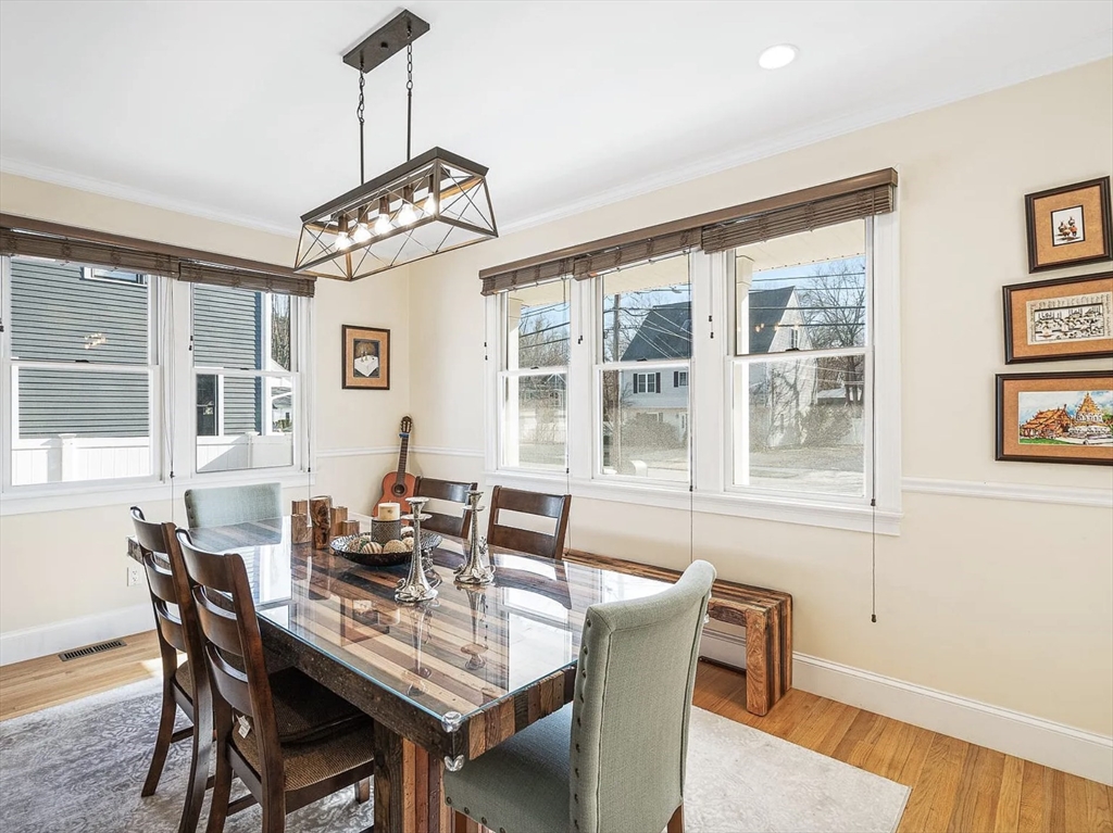 58 Spiers Road Newton, MA 02459 - Photo 19 of 21 a dining room with furniture a chandelier and wooden floor