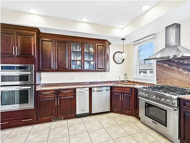 a kitchen with stainless steel appliances granite countertop a stove and a microwave