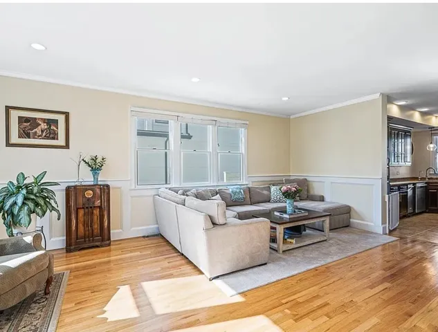 a living room with furniture rug and wooden floor
