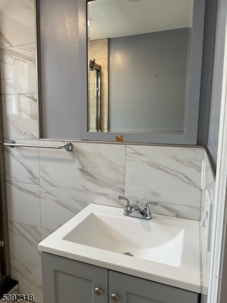 301 Market Street Paterson, NJ 07501 - Photo 5 of 8 a bathroom with a sink and a mirror