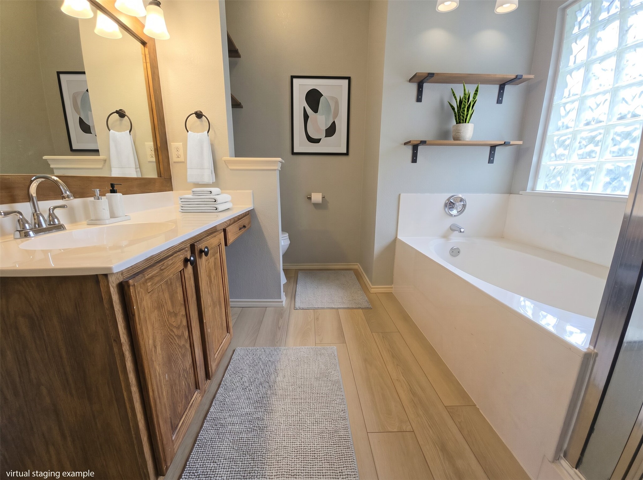 815 Bogart Road Cedar Park, TX 78613 - Photo 10 of 14 Indulge in this well-appointed bath, offering both a vanity with ample storage and a deep soaking tub.