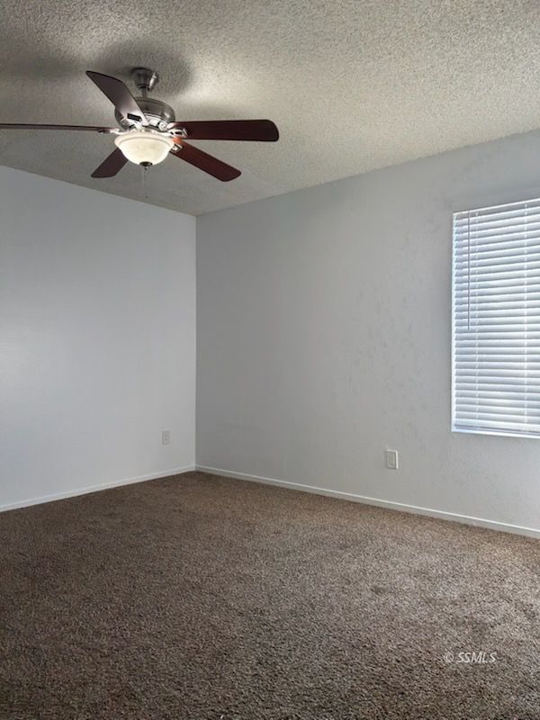 824 C Capehart Court Ridgecrest, CA 93555 - Photo 9 of 11 an empty room with a window and a ceiling fan