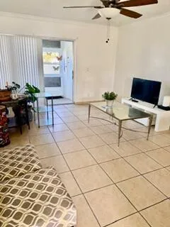 a living room with a couch and a potted plant