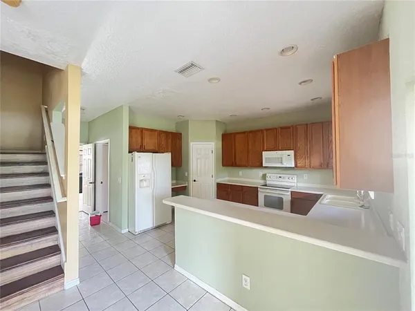 a kitchen with a sink a window and cabinets