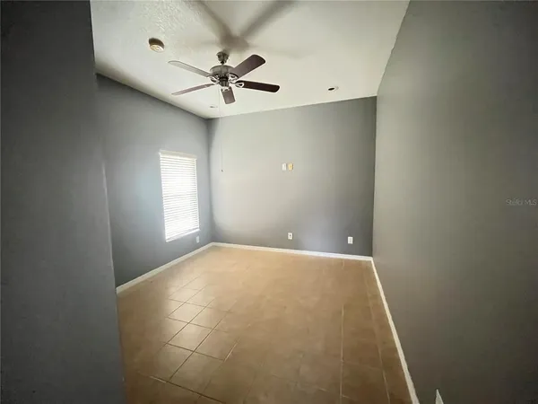 a bathroom with a granite countertop bathtub shower and toilet