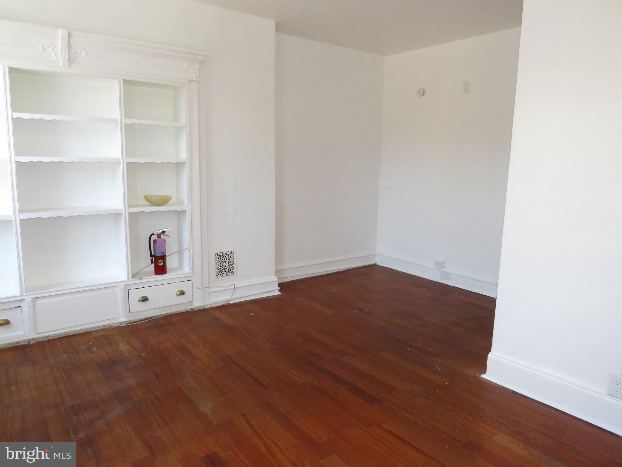 356 East Walnut Lane, Unit 2 Philadelphia, PA 19144 - Photo 11 of 18 a room with white cabinets and wooden floor