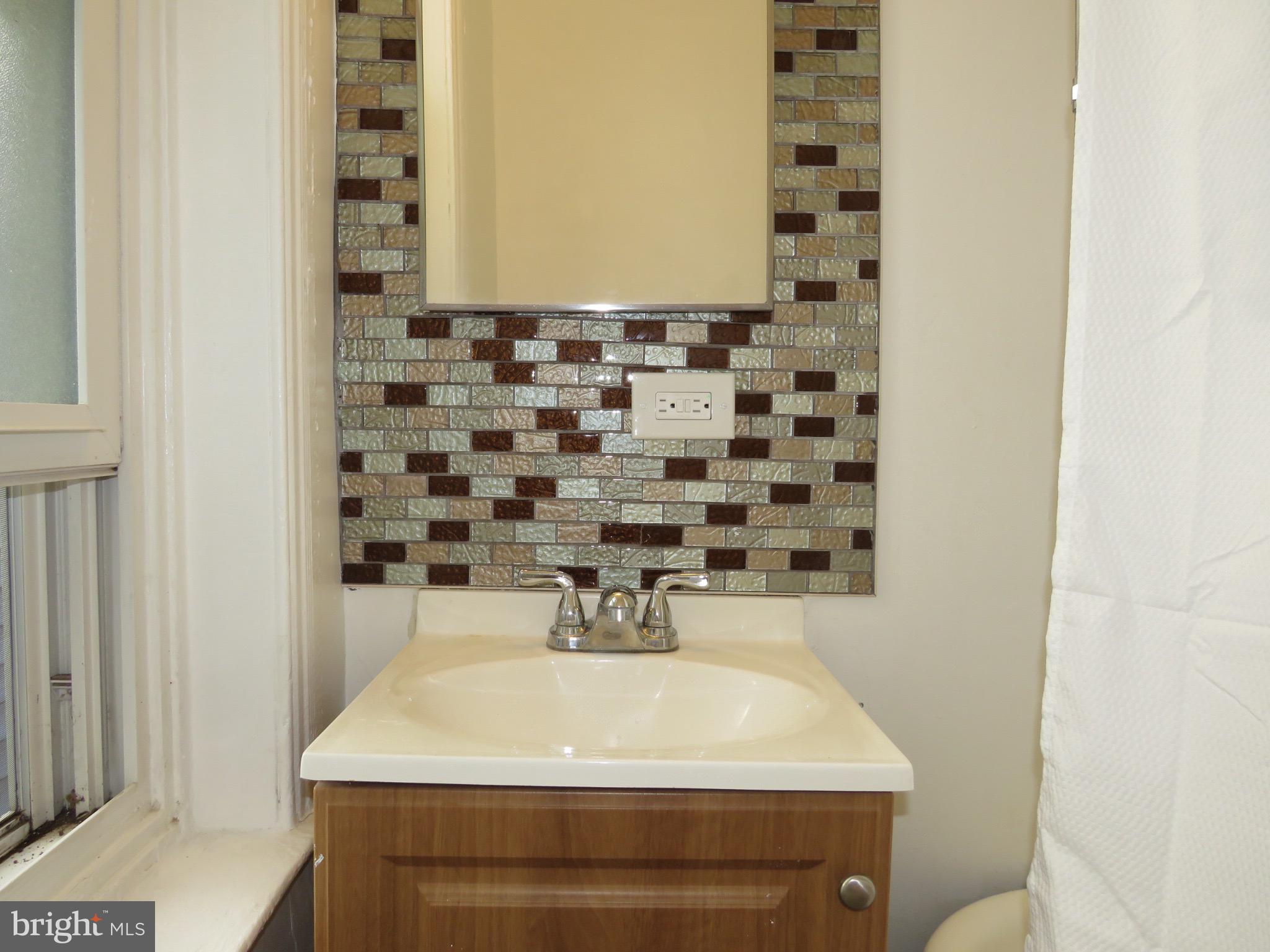 356 East Walnut Lane, Unit 2 Philadelphia, PA 19144 - Photo 13 of 18 a bathroom with a sink and a mirror