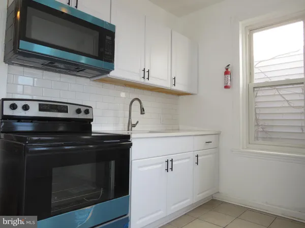 a kitchen with a stove microwave and sink