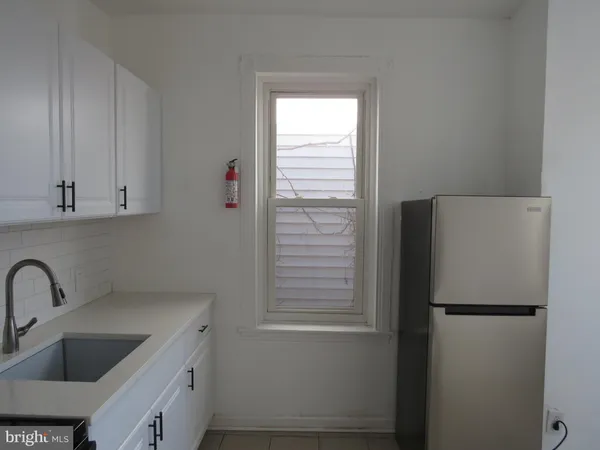 a white refrigerator freezer sitting inside of a kitchen