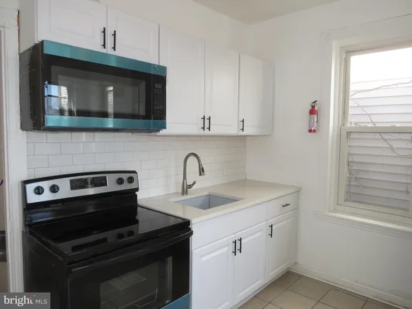 a kitchen with a sink stove and microwave