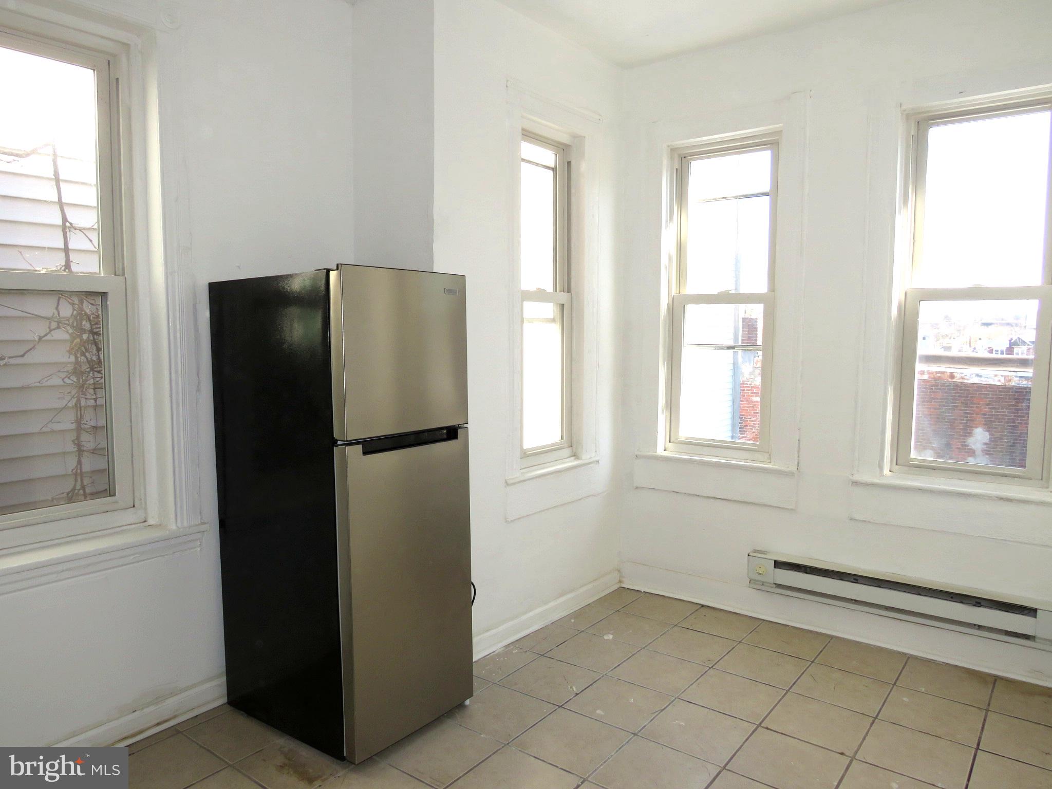 356 East Walnut Lane, Unit 2 Philadelphia, PA 19144 - Photo 7 of 18 a view of kitchen with a refrigerator cabinet and a refrigerator