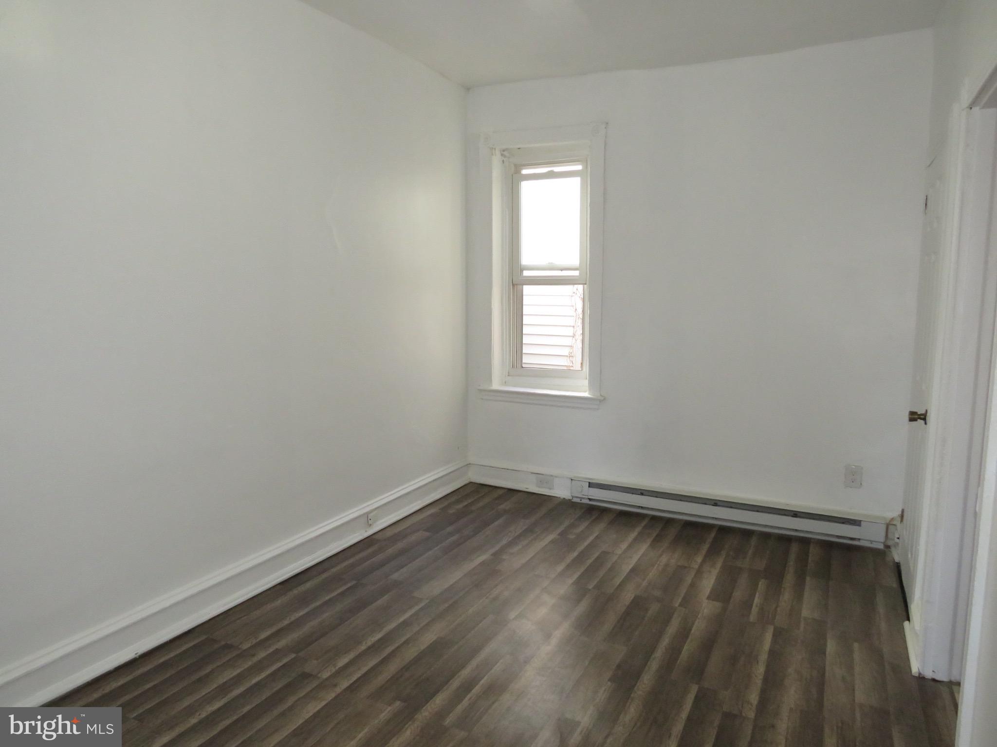 356 East Walnut Lane, Unit 2 Philadelphia, PA 19144 - Photo 9 of 18 an empty room with wooden floor and windows
