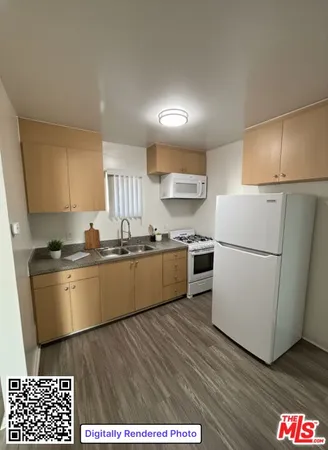 a kitchen with a refrigerator and a stove top oven