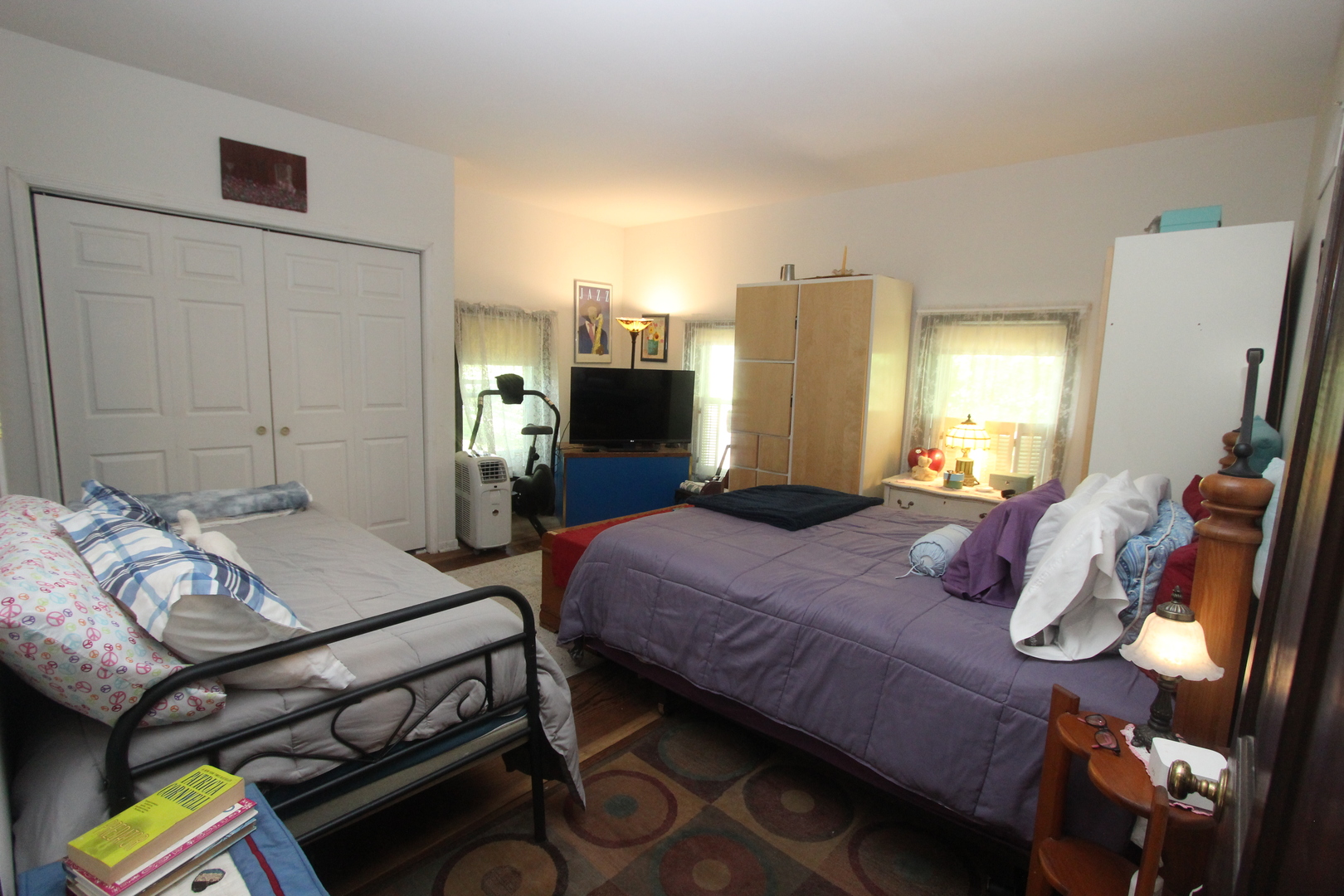 517 Dean Street Woodstock, IL 60098 - Photo 12 of 21 a bedroom with a bed and a chandelier