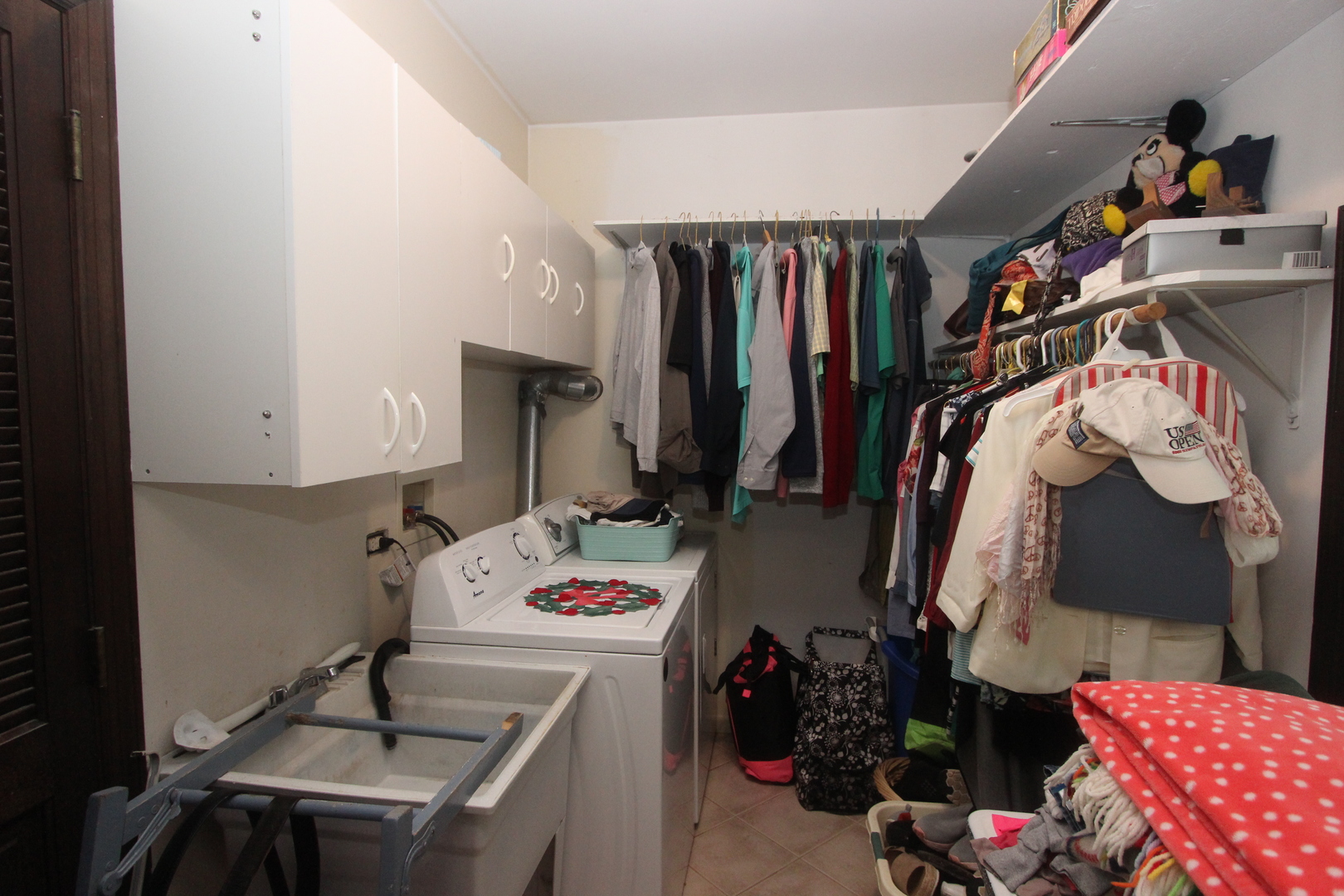 517 Dean Street Woodstock, IL 60098 - Photo 17 of 21 a view of walk in closet with clothes and shoes