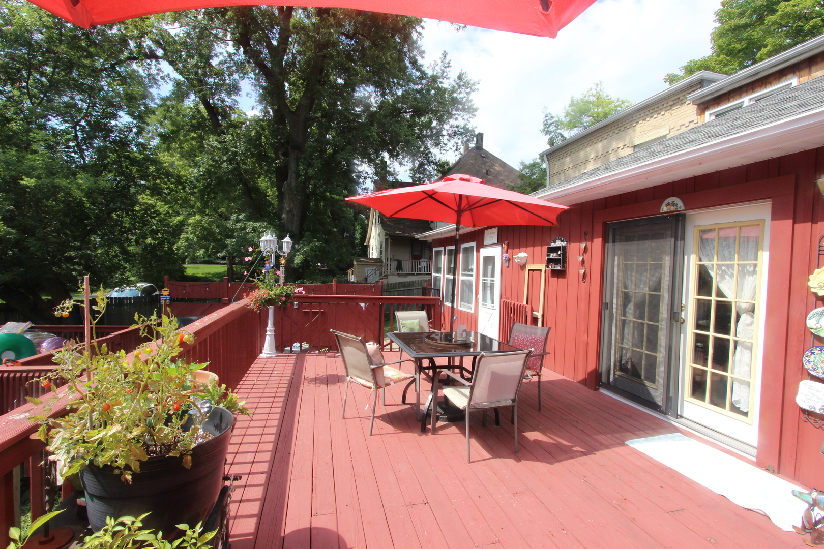 517 Dean Street Woodstock, IL 60098 - Photo 18 of 21 a view of a patio with table and chairs under an umbrella with a barbeque