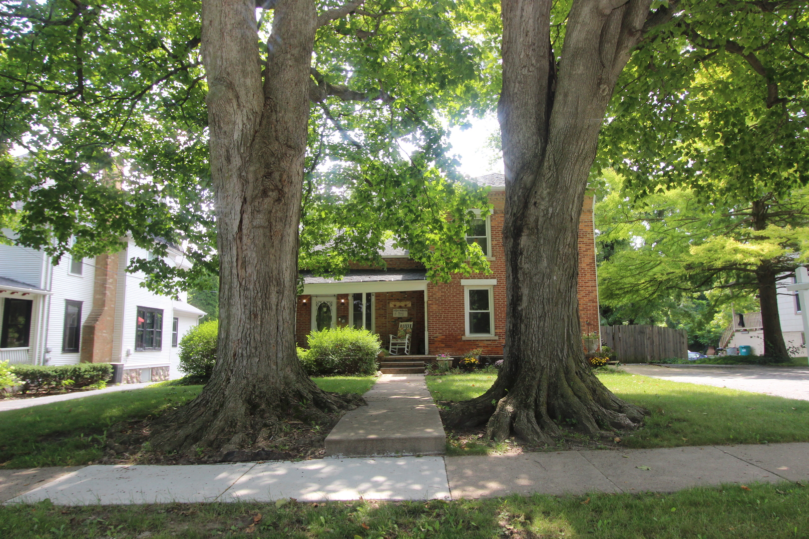 517 Dean Street Woodstock, IL 60098 - Photo 2 of 21 a view of a yard in front of a house with large tree