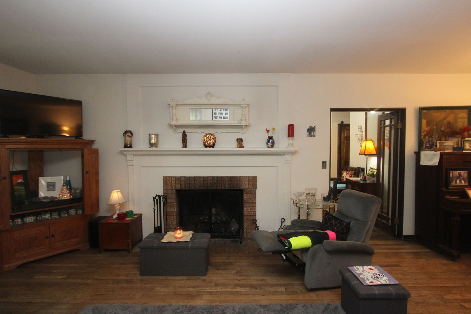 517 Dean Street Woodstock, IL 60098 - Photo 8 of 21 a living room with furniture a flat screen tv and a fireplace