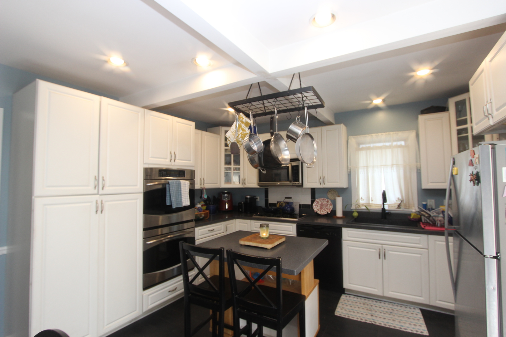 517 Dean Street Woodstock, IL 60098 - Photo 9 of 21 a kitchen with refrigerator cabinets and furniture