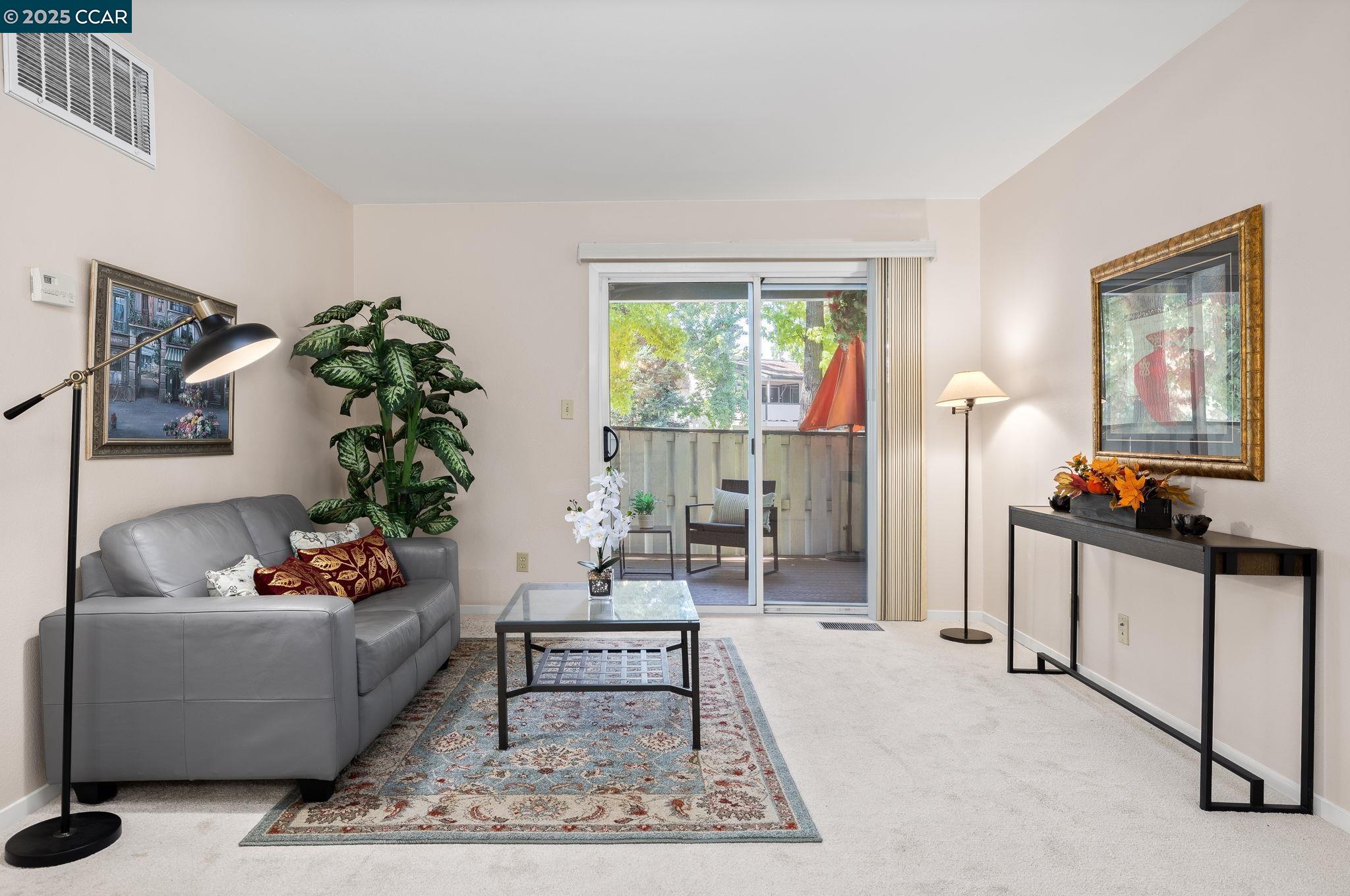 a living room with furniture and a potted plant