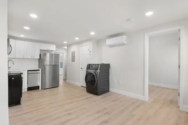 a view of kitchen with refrigerator and microwave