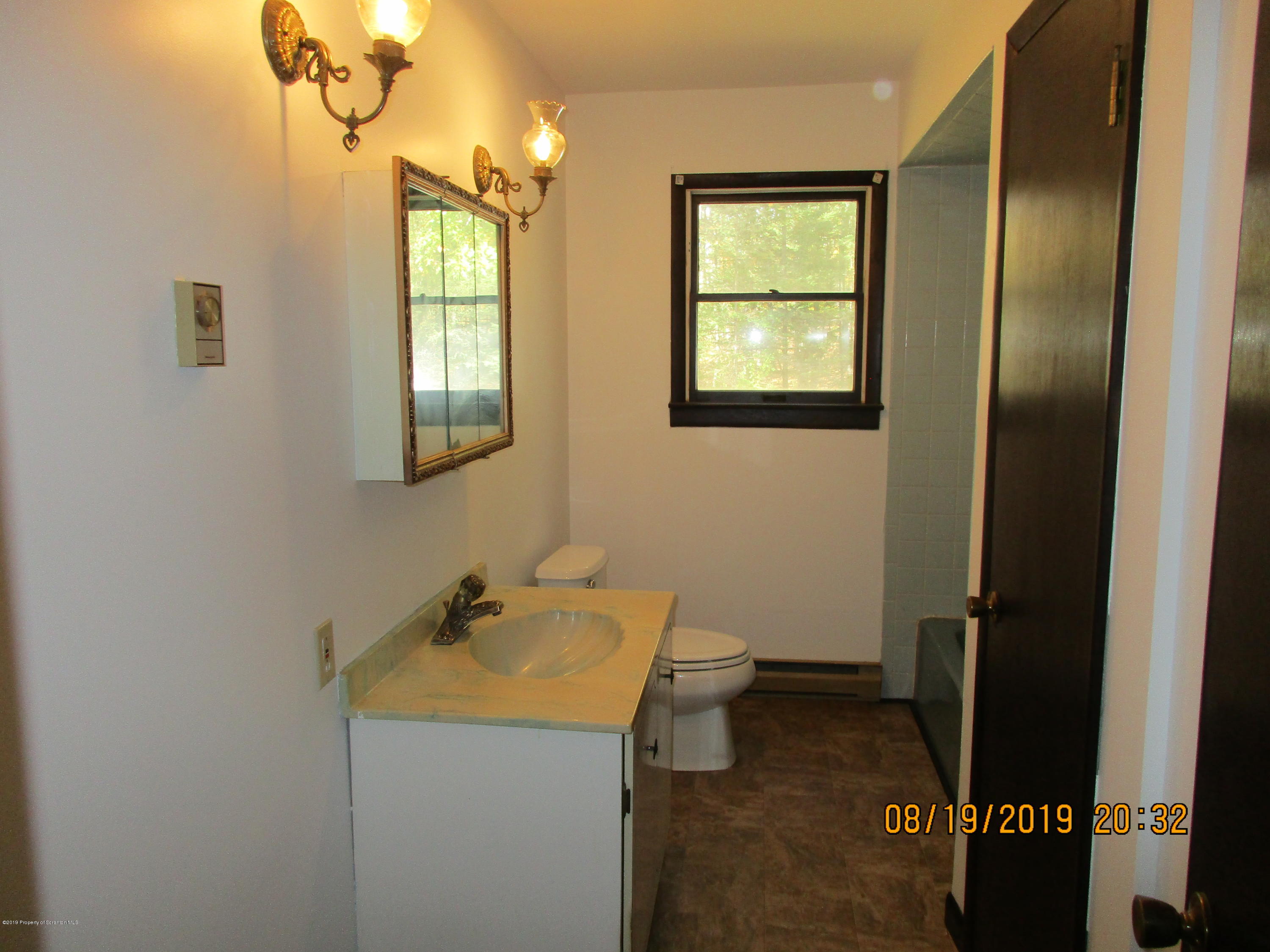 309 Rail Road Nicholson, PA 18446 - Photo 14 of 29 a bathroom with a sink a toilet and window