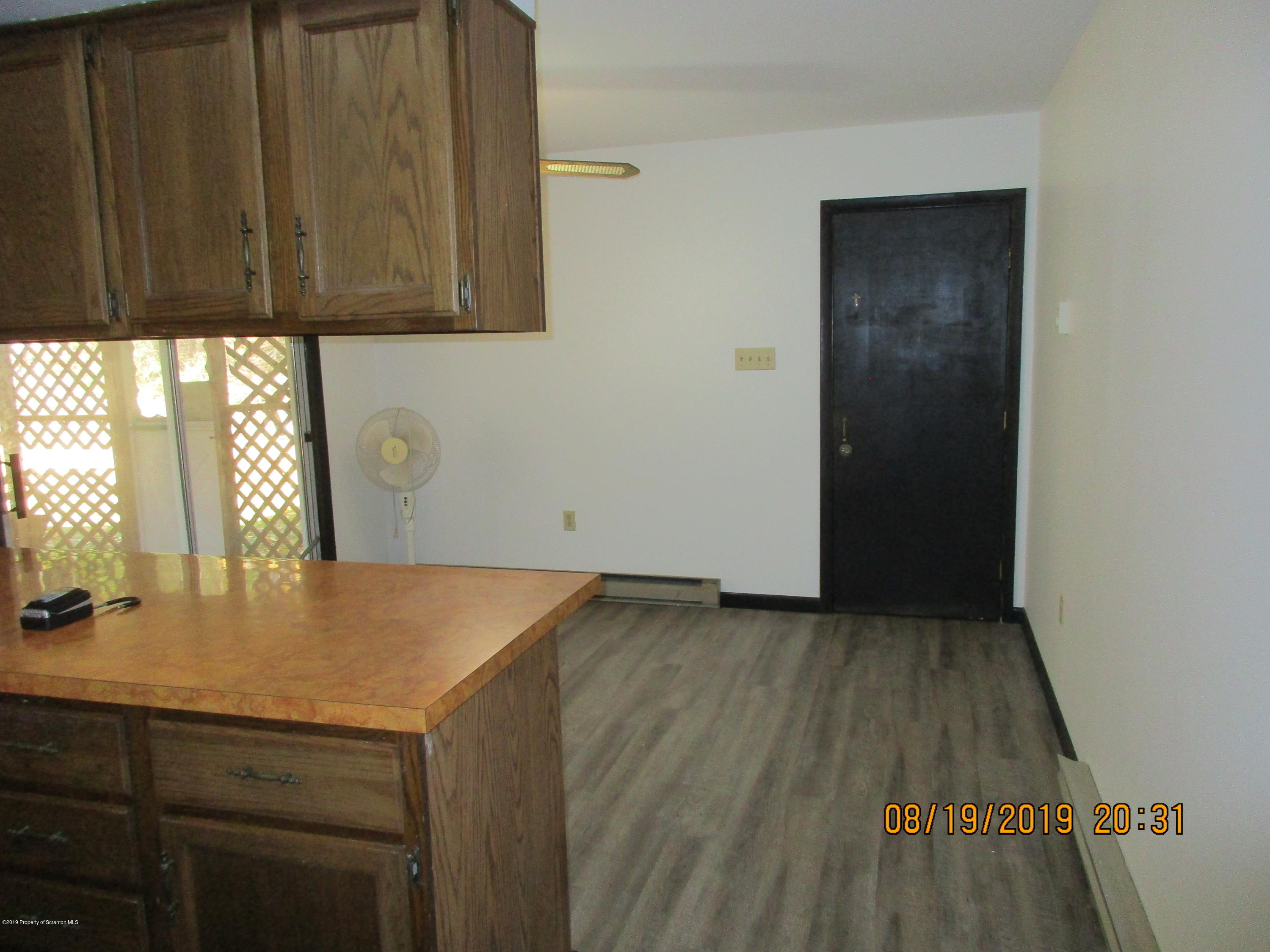 309 Rail Road Nicholson, PA 18446 - Photo 10 of 29 an empty room with wooden floor and cabinet