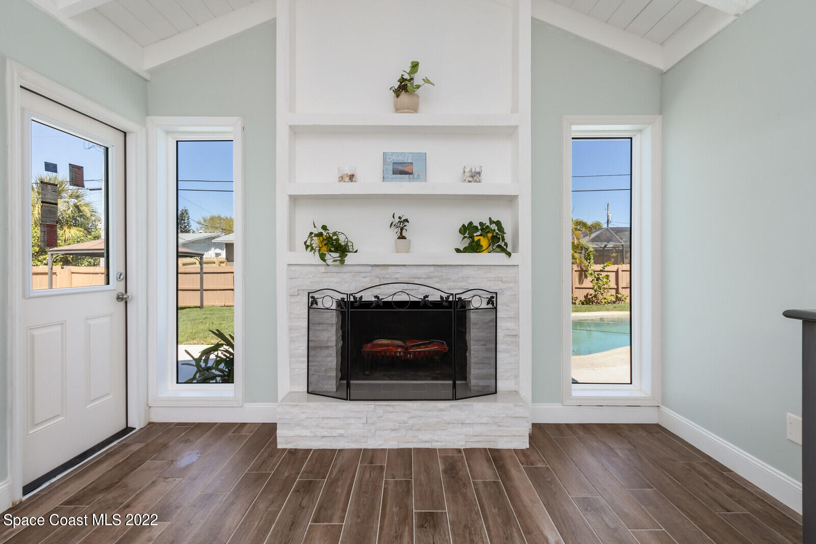 210 Sand Pine Road Indialantic, FL 32903 - Photo 15 of 45 a living room with a fireplace and a window
