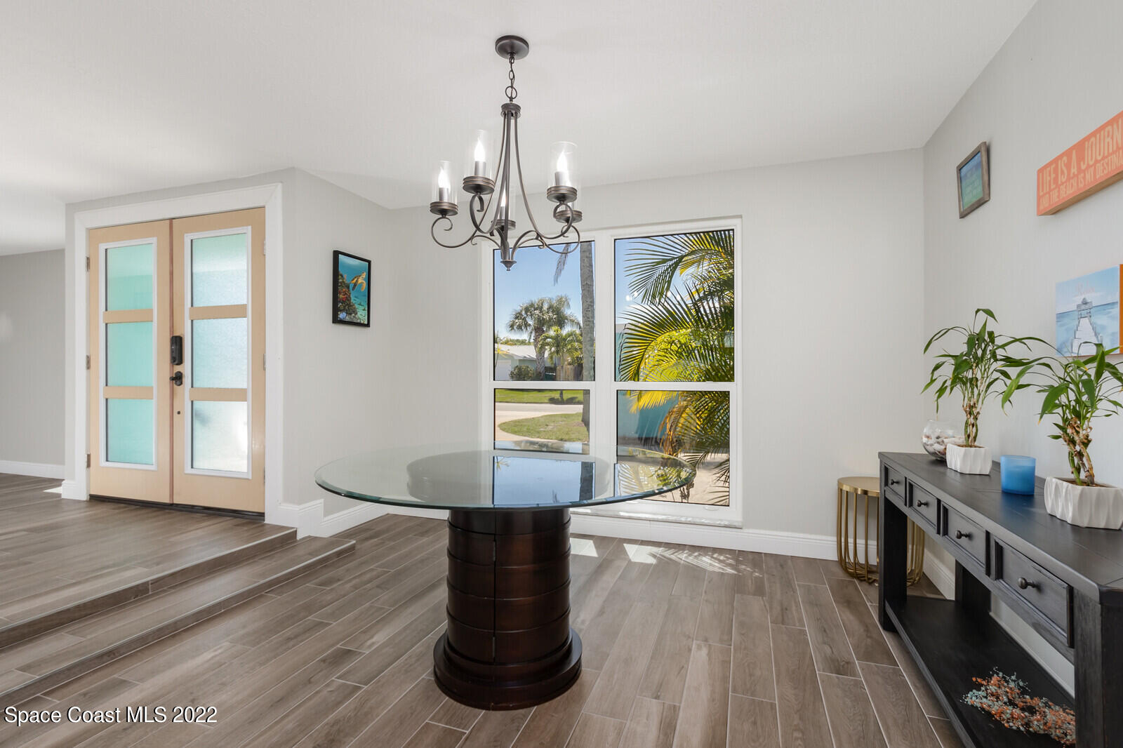 210 Sand Pine Road Indialantic, FL 32903 - Photo 10 of 45 a view of a room with wooden floor and windows