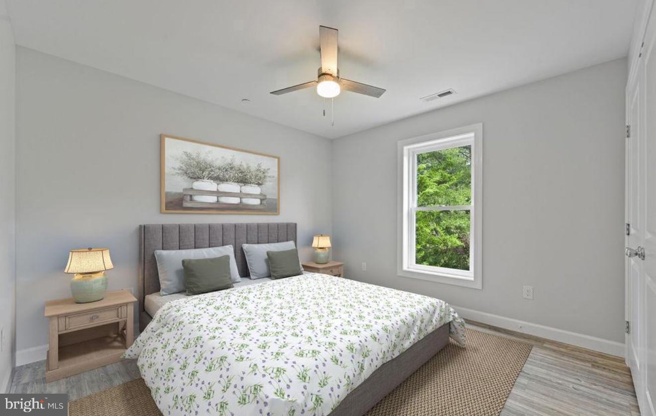 3390 Jefferson Pond Road Federalsburg, MD 21632 - Photo 5 of 5 a bedroom with a large bed and a chandelier