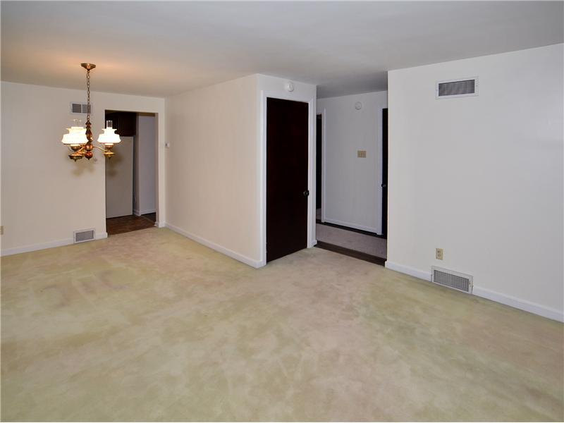 306 Murrysville Road Level Green, PA 15085 - Photo 11 of 21 Dining Room. Open floor plan with dining room and living room. Hardwood floors under carpeting.
