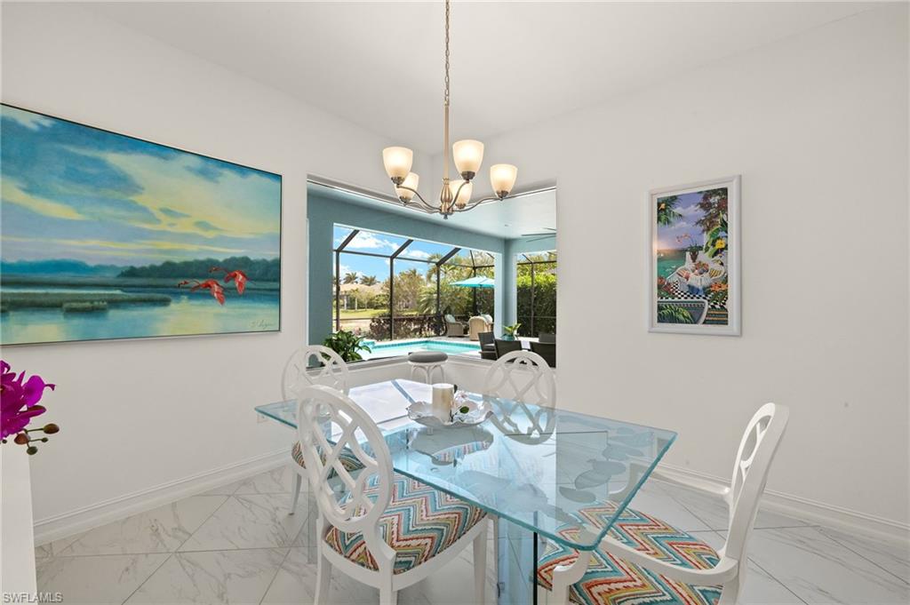 14809 Windward Lane Naples, FL 34114 - Photo 13 of 50 a view of a dining room with furniture wooden floor and a chandelier