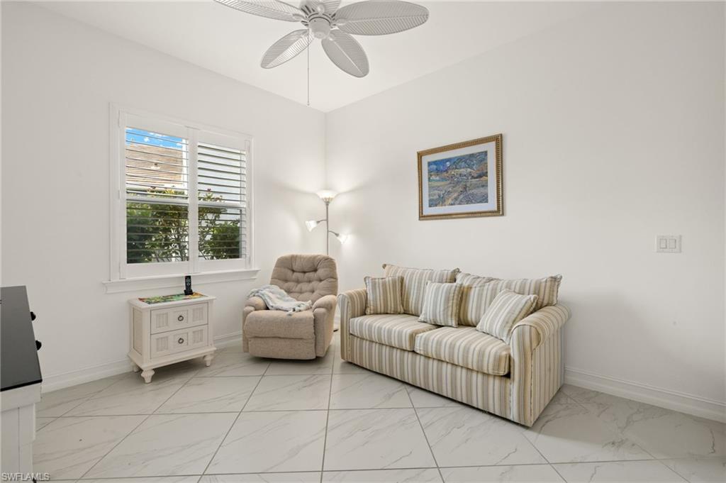 14809 Windward Lane Naples, FL 34114 - Photo 15 of 50 a living room with furniture and a large window