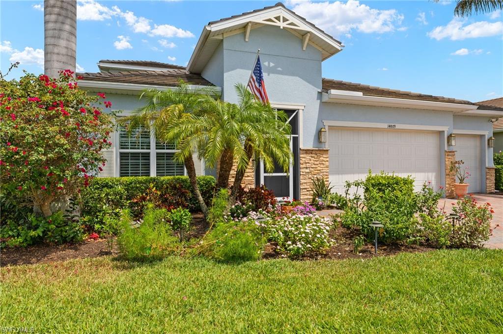 14809 Windward Lane Naples, FL 34114 - Photo 2 of 50 a front view of a house with a yard