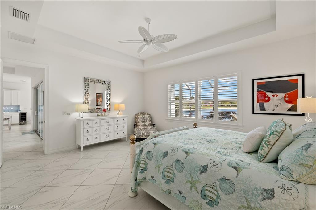 14809 Windward Lane Naples, FL 34114 - Photo 21 of 50 a bedroom with a bed and a large window