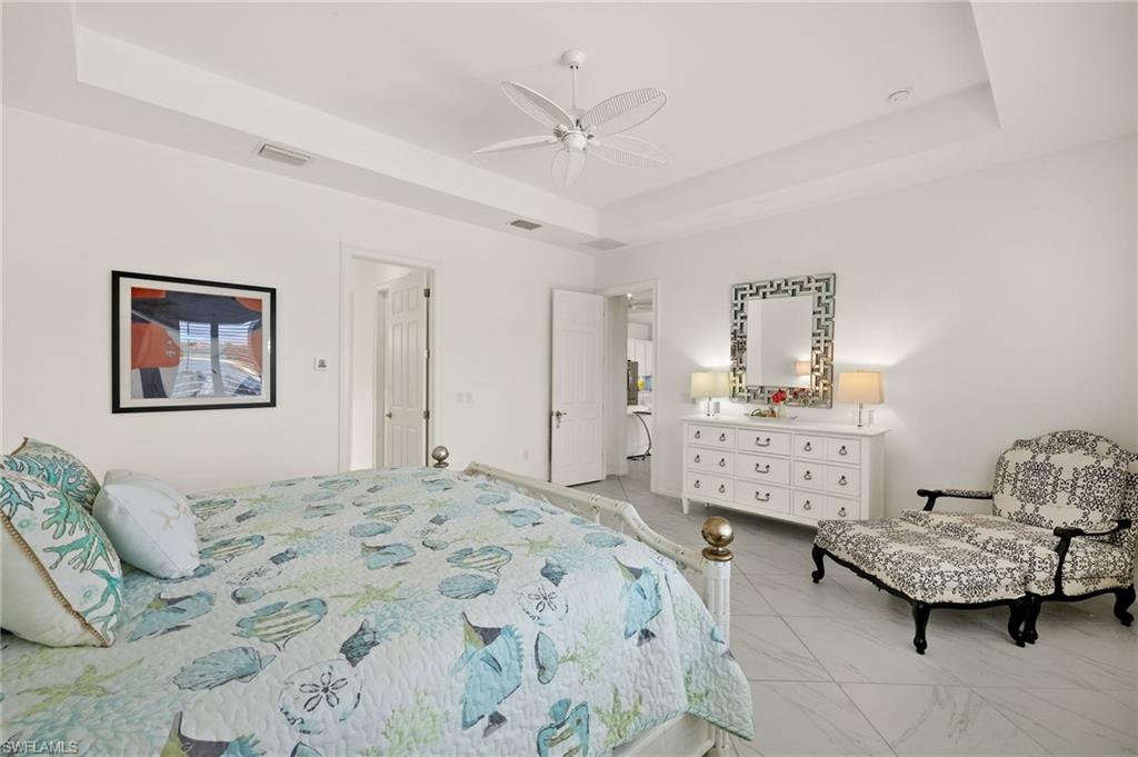 14809 Windward Lane Naples, FL 34114 - Photo 22 of 50 a bedroom with a bed and furniture