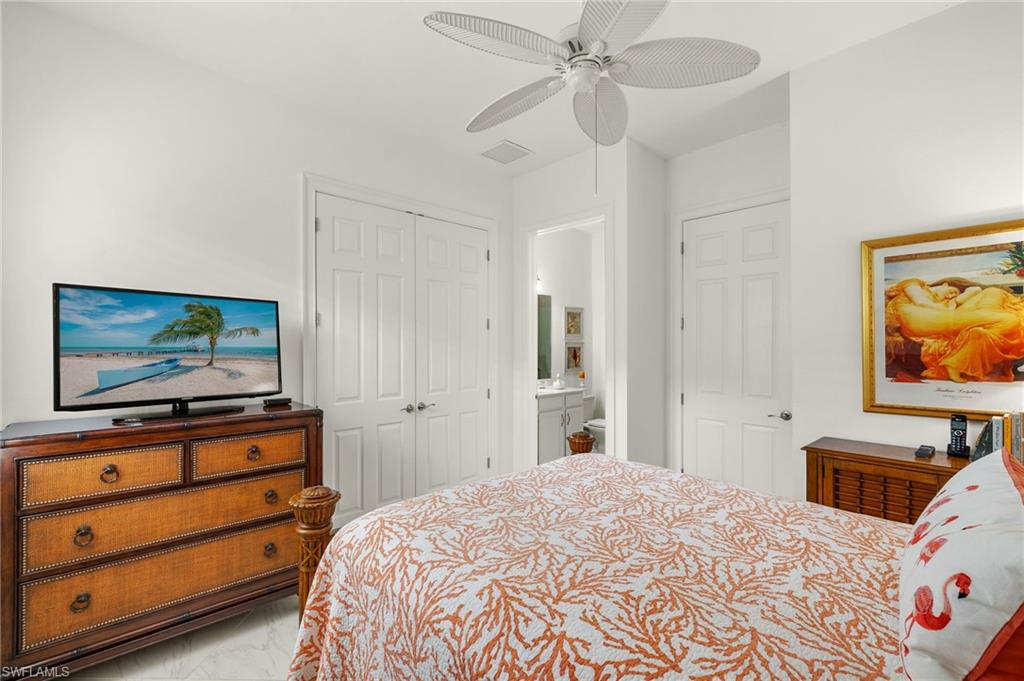 14809 Windward Lane Naples, FL 34114 - Photo 27 of 50 a bedroom with a bed and a flat screen tv