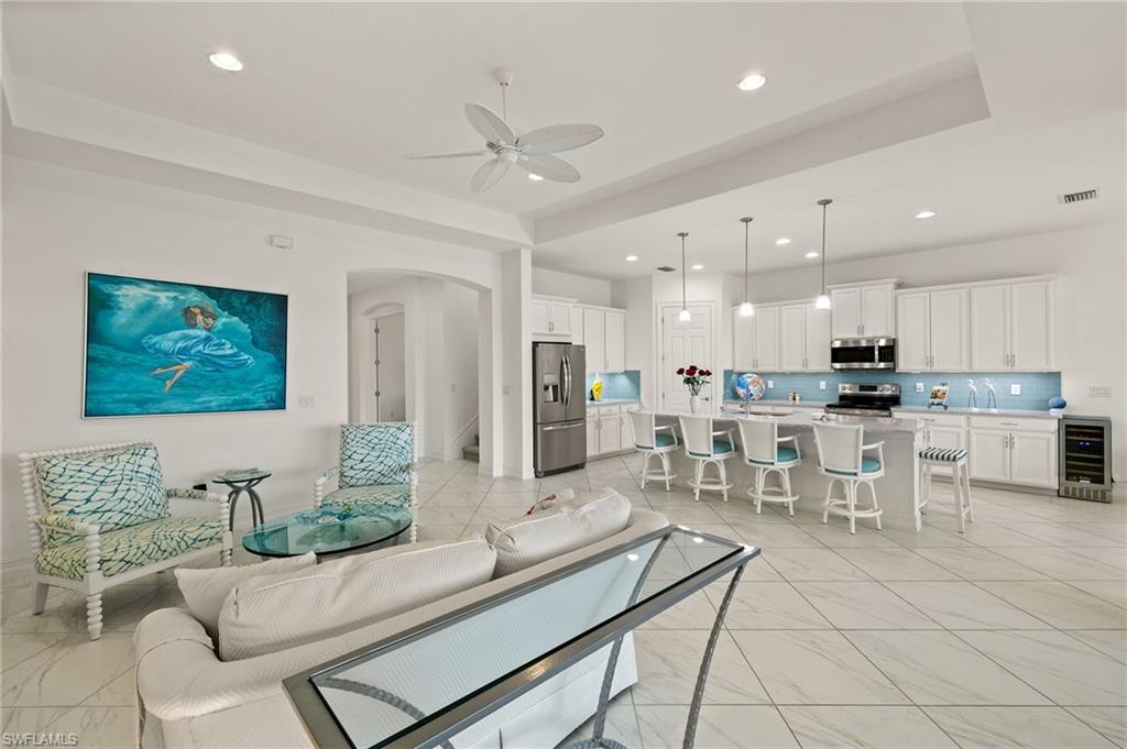 14809 Windward Lane Naples, FL 34114 - Photo 3 of 50 a living room with furniture and a view of kitchen
