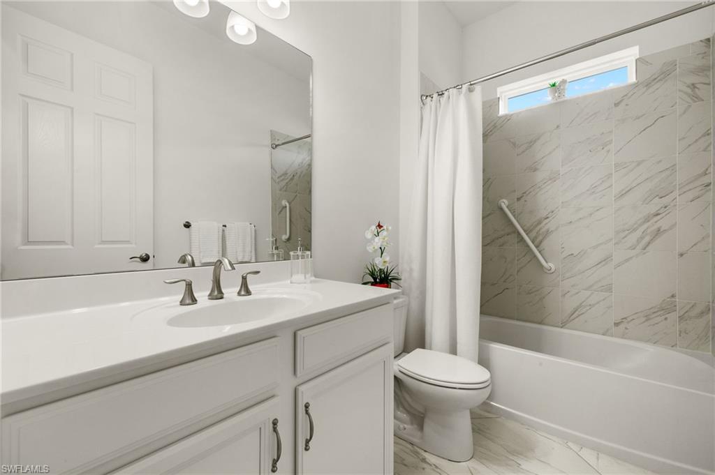 14809 Windward Lane Naples, FL 34114 - Photo 31 of 50 a bathroom with a sink a toilet and a bathtub