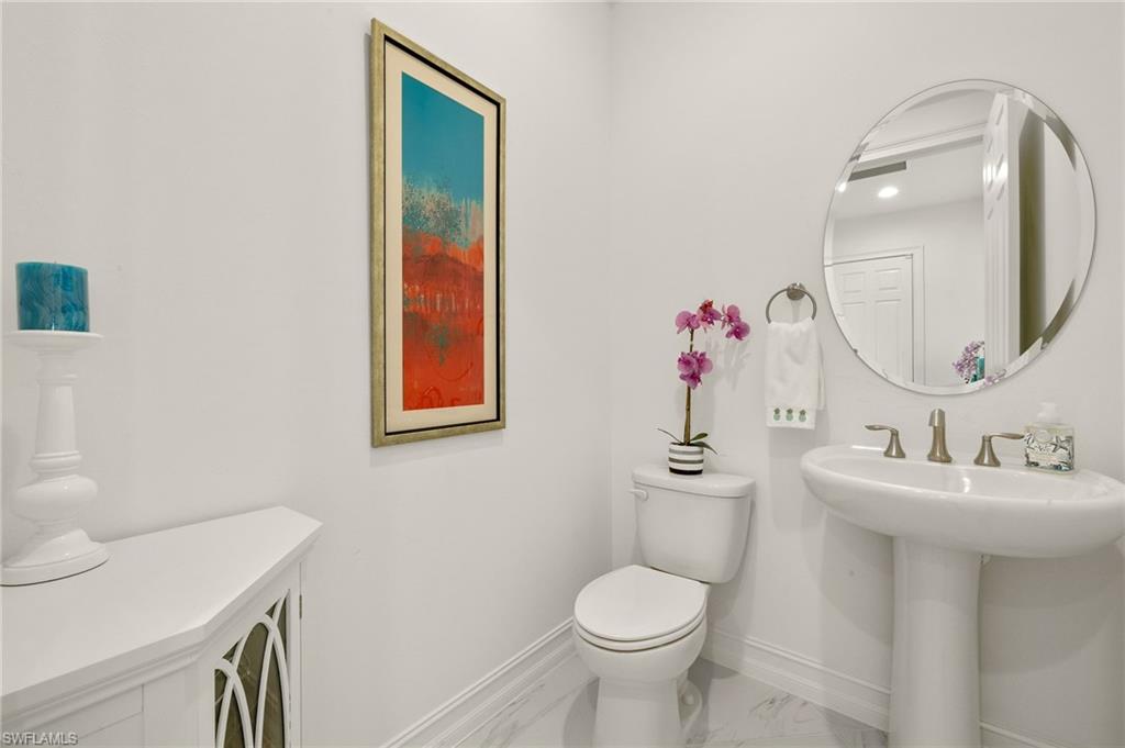 14809 Windward Lane Naples, FL 34114 - Photo 32 of 50 a bathroom with a sink vanity mirror and toilet