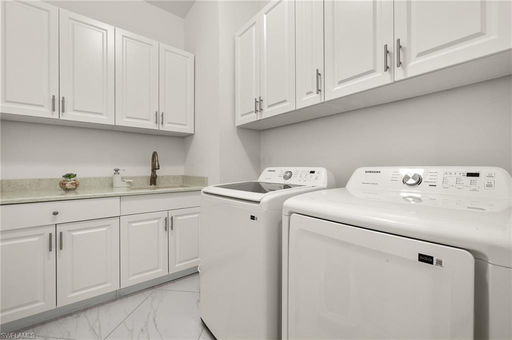 14809 Windward Lane Naples, FL 34114 - Photo 33 of 50 a utility room with dryer and washer