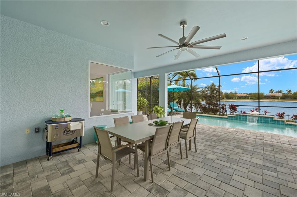 14809 Windward Lane Naples, FL 34114 - Photo 34 of 50 a dining room with furniture and a floor to ceiling window