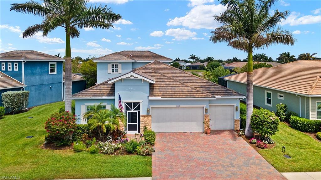 14809 Windward Lane Naples, FL 34114 - Photo 39 of 50 a front view of a house with a garden and palm trees
