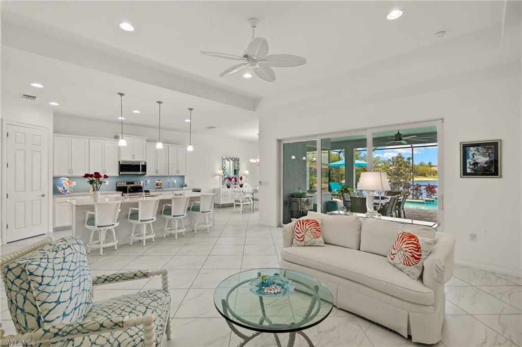 14809 Windward Lane Naples, FL 34114 - Photo 4 of 50 a living room with furniture kitchen and a table